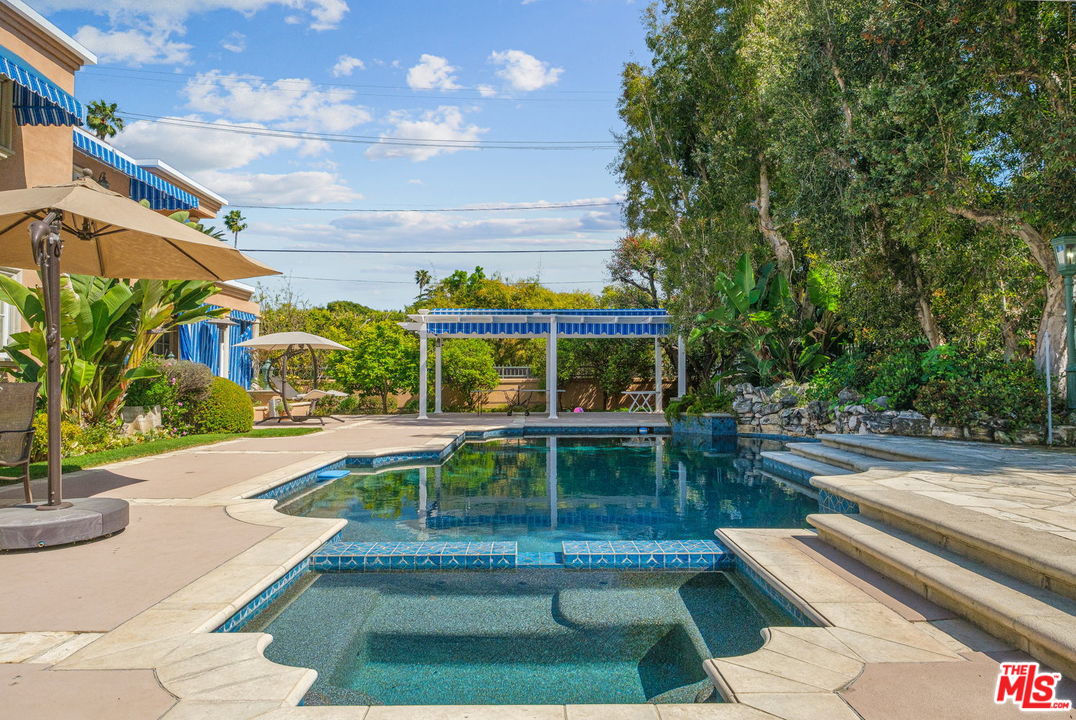 511 North Canon Drive Beverly Hills, CA 90210 - Photo 31 of 34 a view of a swimming pool with a patio