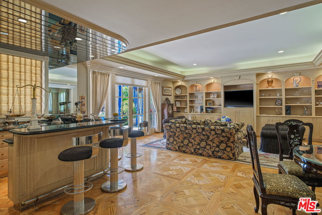 511 North Canon Drive Beverly Hills, CA 90210 - Photo 8 of 34 a room with lots of chairs and mirrors