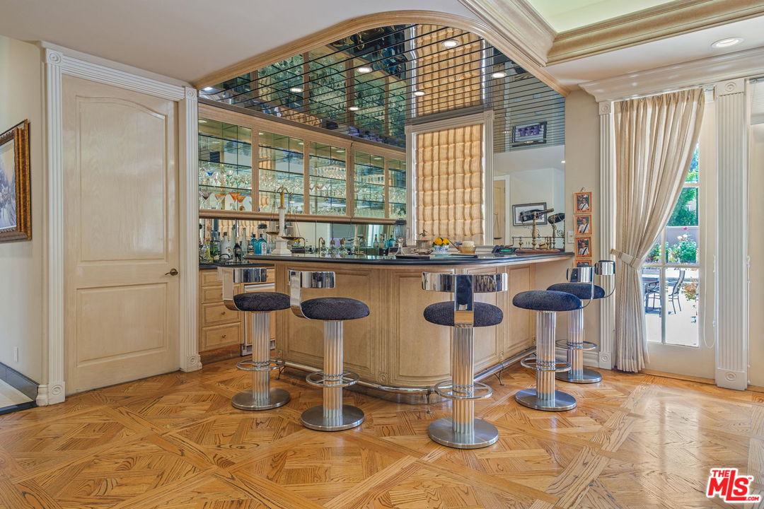 511 North Canon Drive Beverly Hills, CA 90210 - Photo 9 of 34 a dining room with furniture and a window