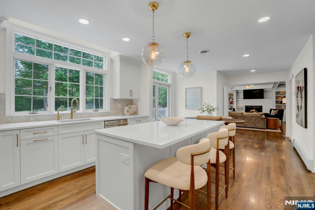 48 Hopper Farm Road Upper Saddle River, NJ 07458 - Photo 10 of 43 a large kitchen with kitchen island a large island in it