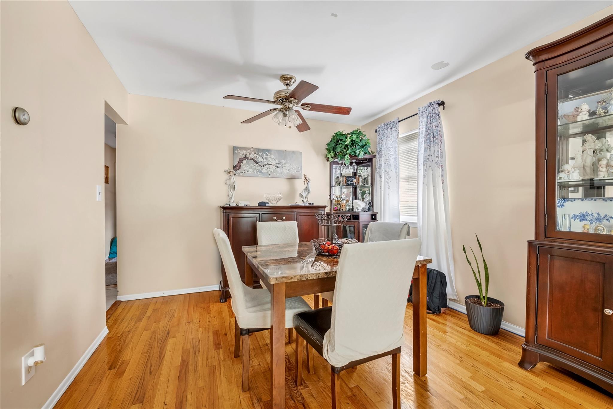 151-84 17th Road Queens, NY 11357 - Photo 12 of 17 Dining area featuring a ceiling fan, light wood-style flooring, and baseboards