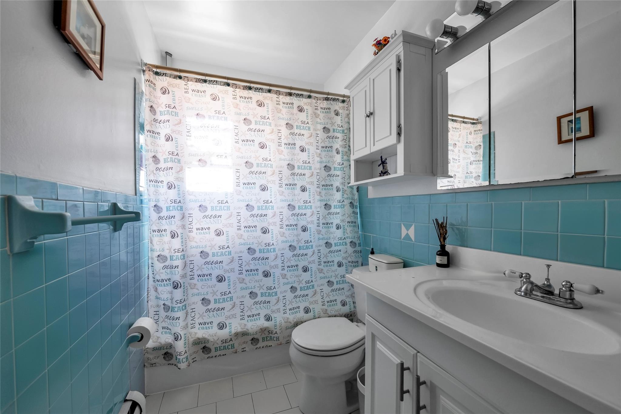 151-84 17th Road Queens, NY 11357 - Photo 15 of 17 Full bath with tile walls, tile patterned floors, toilet, shower / tub combo with curtain, and vanity