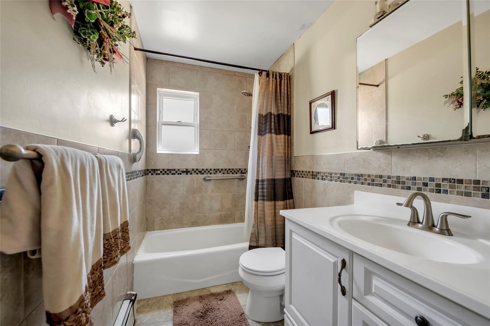 151-84 17th Road Queens, NY 11357 - Photo 9 of 17 Full bathroom with tile walls, toilet, vanity, shower / tub combo, and tile patterned flooring