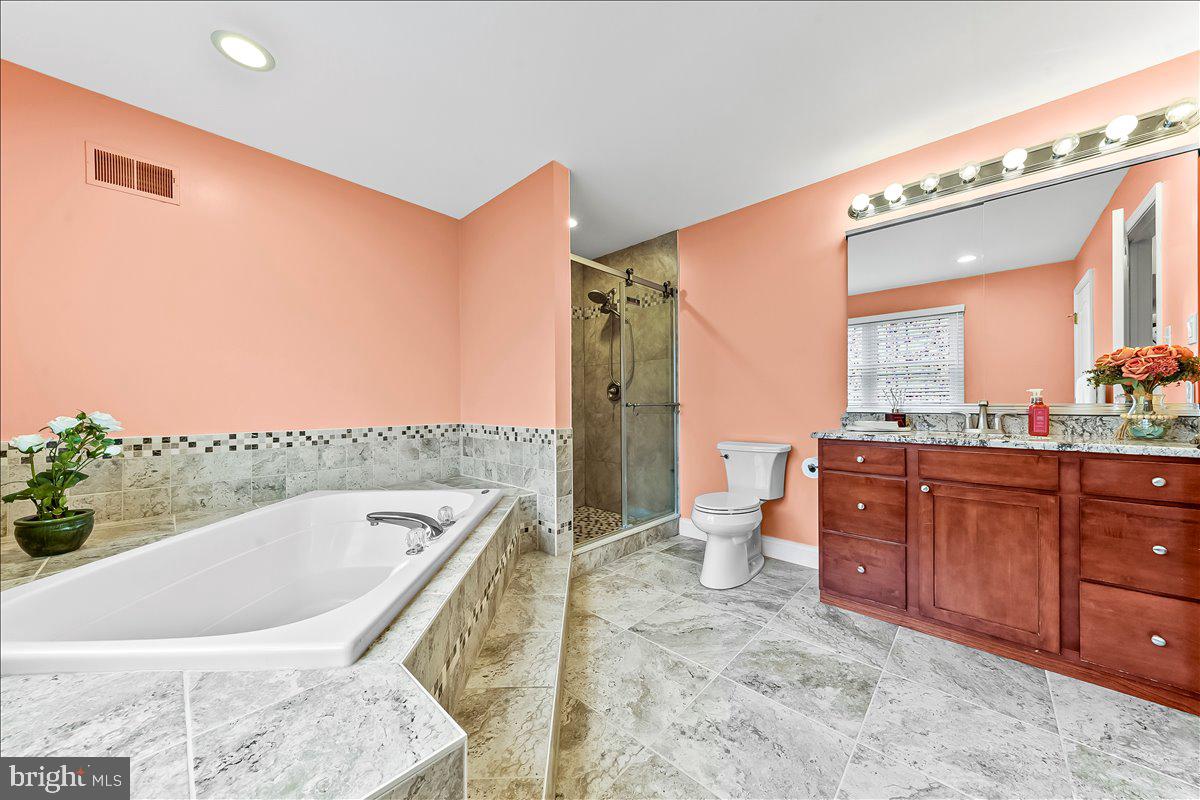 408 Brentford Road Kennett Square, PA 19348 - Photo 25 of 41 a spacious bathroom with a granite countertop sink and a large mirror