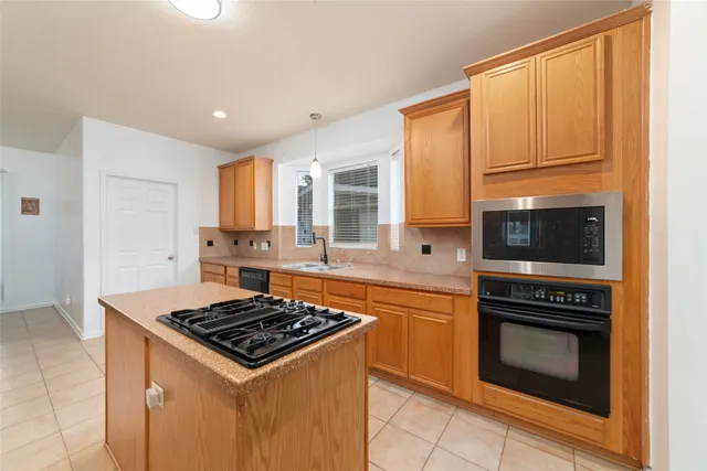 a large kitchen with stainless steel appliances kitchen island granite countertop a large counter top stainless steel appliances and cabinets