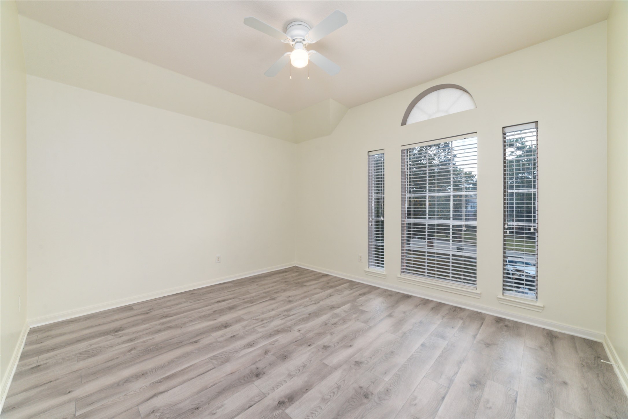 9003 Memorial Hills Drive Spring, TX 77379 - Photo 32 of 39 an empty room with wooden floor fan and windows