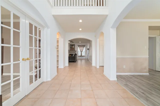 a view of a hallway with wooden floor and windows