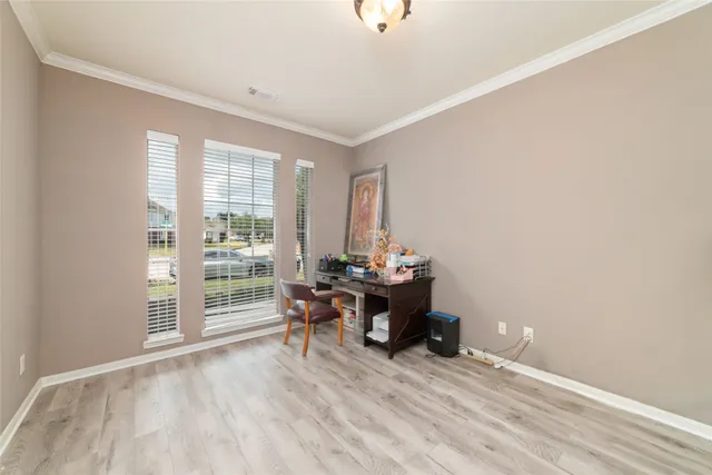 a view of a workspace with furniture and a window