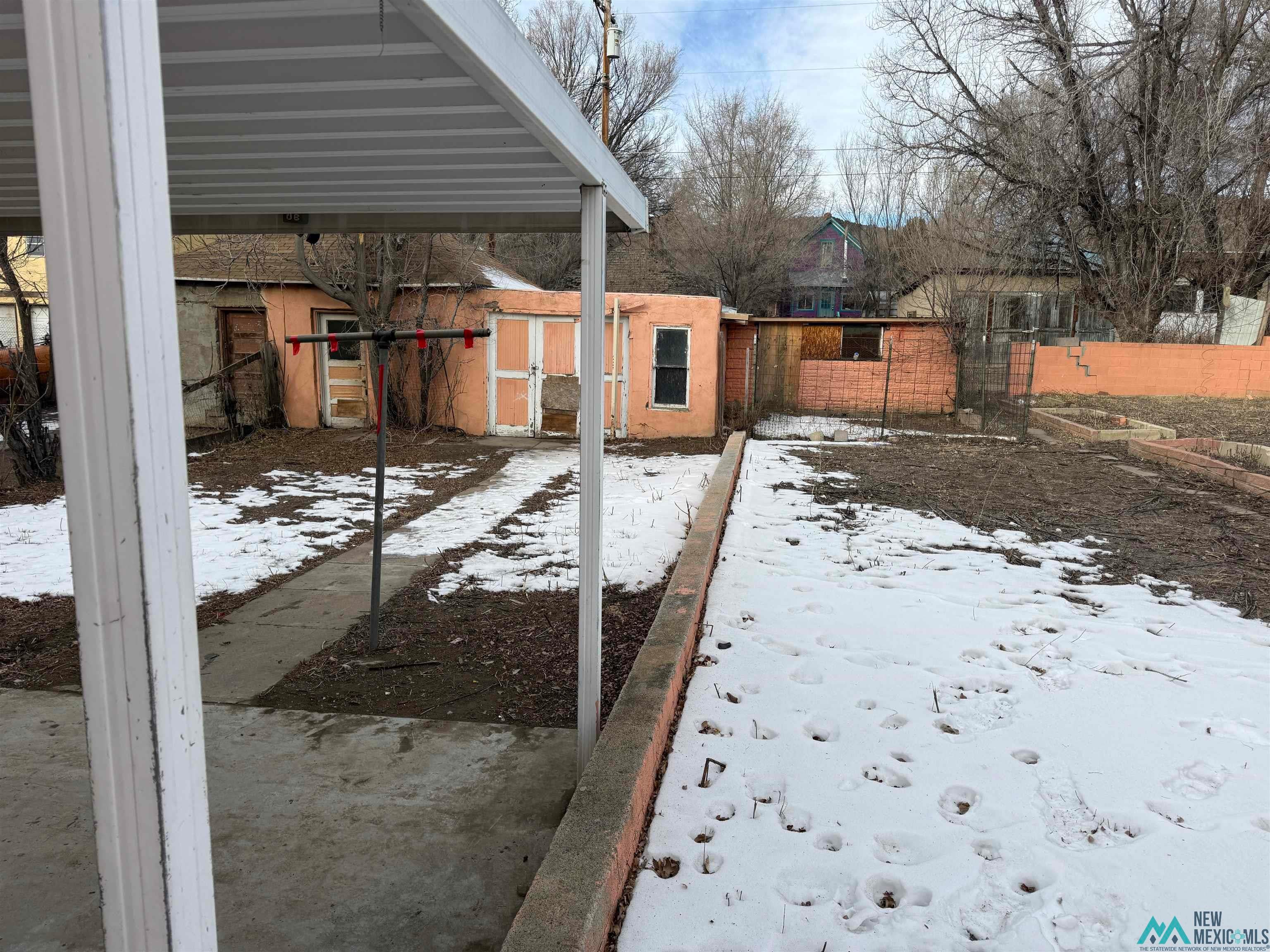 524 South 1st Street Raton, NM 87740 - Photo 20 of 21 Yard covered in snow with an outdoor structure
