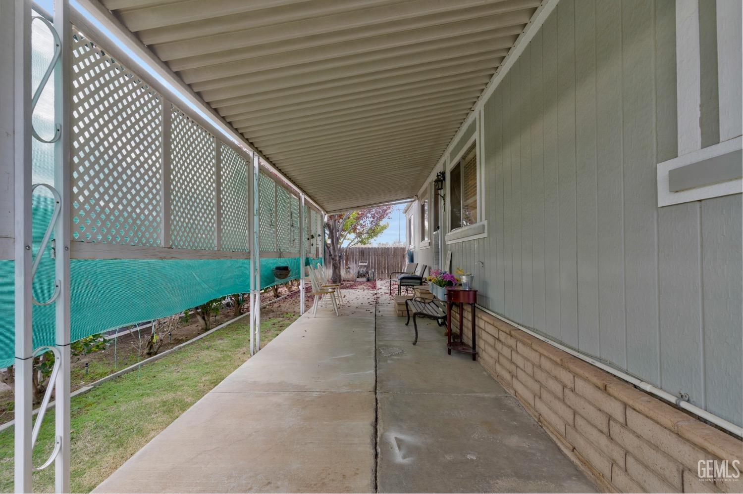 Undisclosed Address Bakersfield, CA 93306 - Photo 13 of 26 a view of a patio with table and chairs with wooden floor and fence