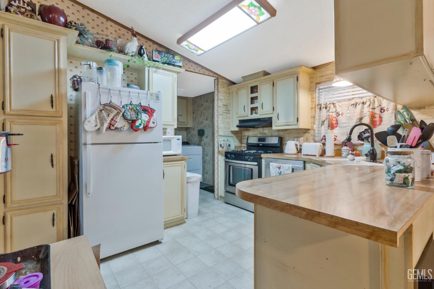 Undisclosed Address Bakersfield, CA 93306 - Photo 14 of 26 a kitchen with refrigerator and cabinets
