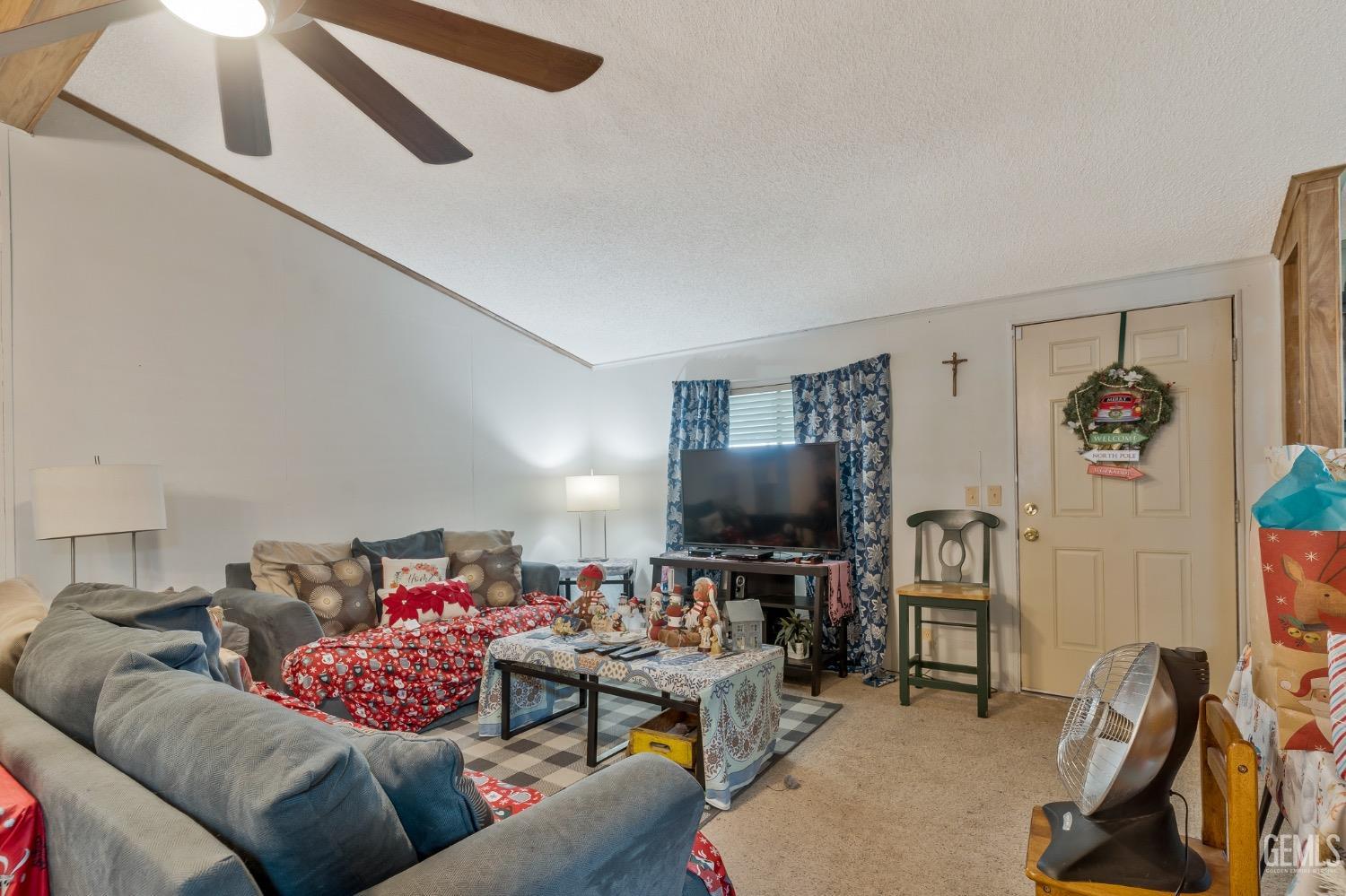 Undisclosed Address Bakersfield, CA 93306 - Photo 16 of 26 a living room with furniture and a flat screen tv