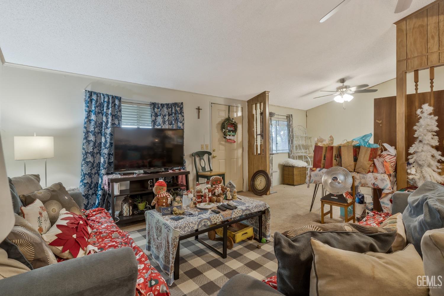 Undisclosed Address Bakersfield, CA 93306 - Photo 19 of 26 a living room with furniture and a flat screen tv
