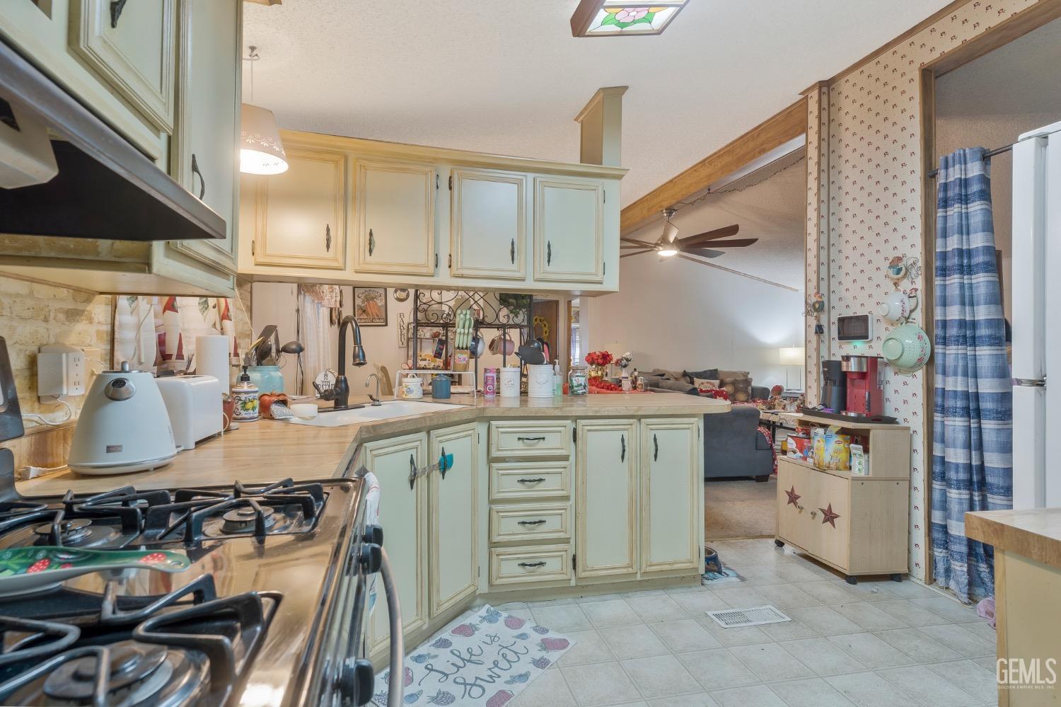 Undisclosed Address Bakersfield, CA 93306 - Photo 3 of 26 a kitchen with stainless steel appliances granite countertop a stove and a sink