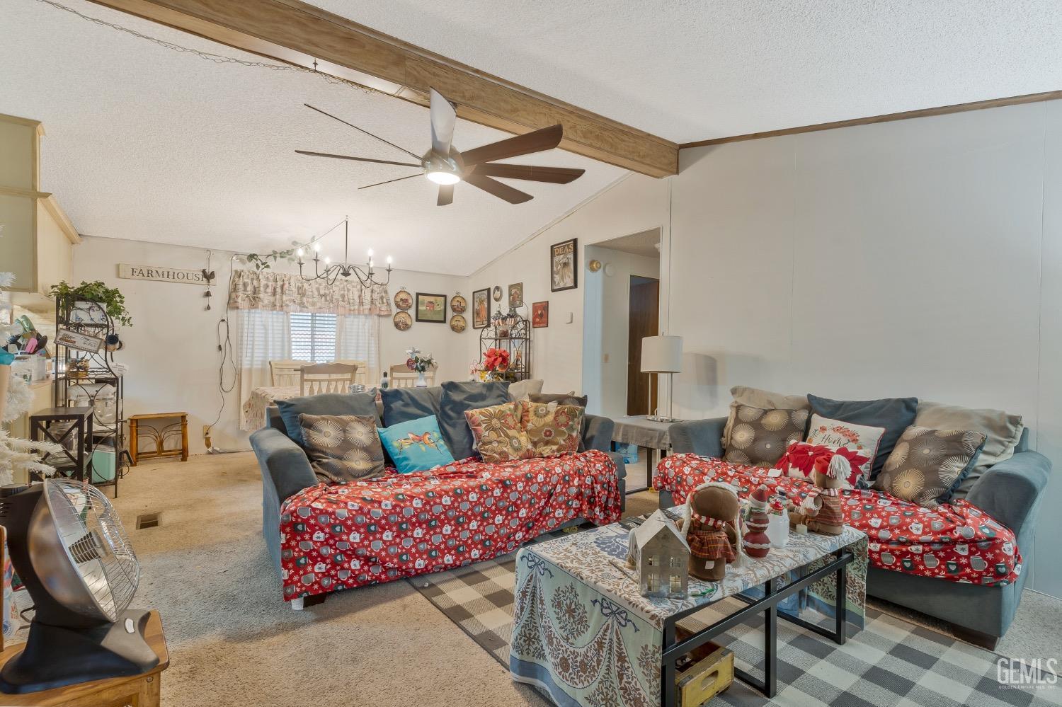 Undisclosed Address Bakersfield, CA 93306 - Photo 5 of 26 a living room with furniture and a chandelier