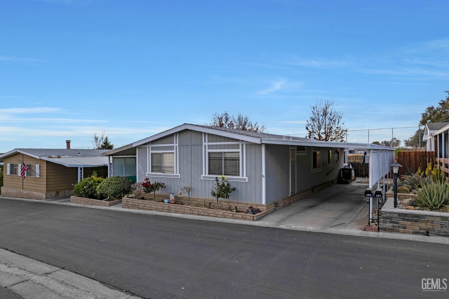 Undisclosed Address Bakersfield, CA 93306 - Photo 6 of 26 a front view of a house with a yard