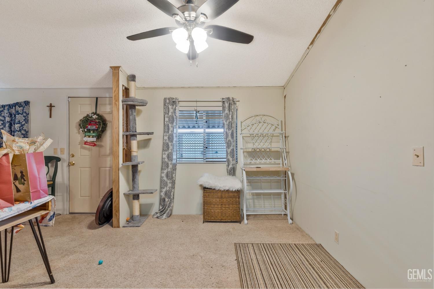 Undisclosed Address Bakersfield, CA 93306 - Photo 9 of 26 a view of a livingroom with furniture and a ceiling fan