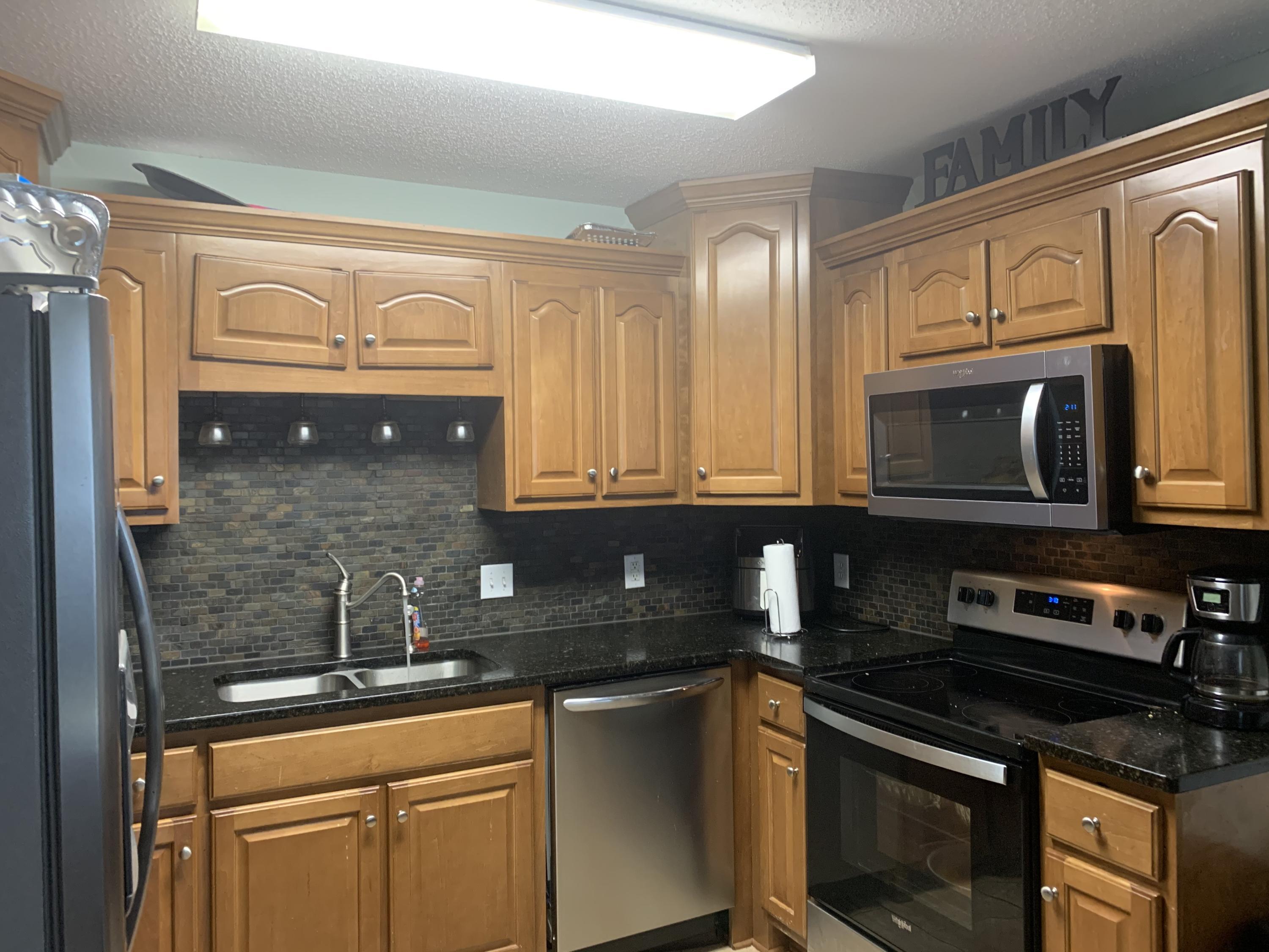 479 Bob White Road Macon, GA 31216 - Photo 8 of 9 a kitchen with stainless steel appliances granite countertop a stove microwave and sink