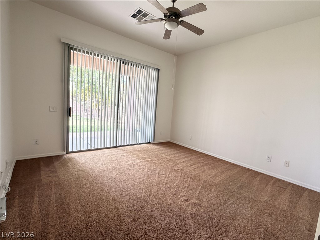 16 Caprington Road Henderson, NV 89052 - Photo 7 of 16 Sliding glass doors open directly to the outdoors from this carpeted living space.