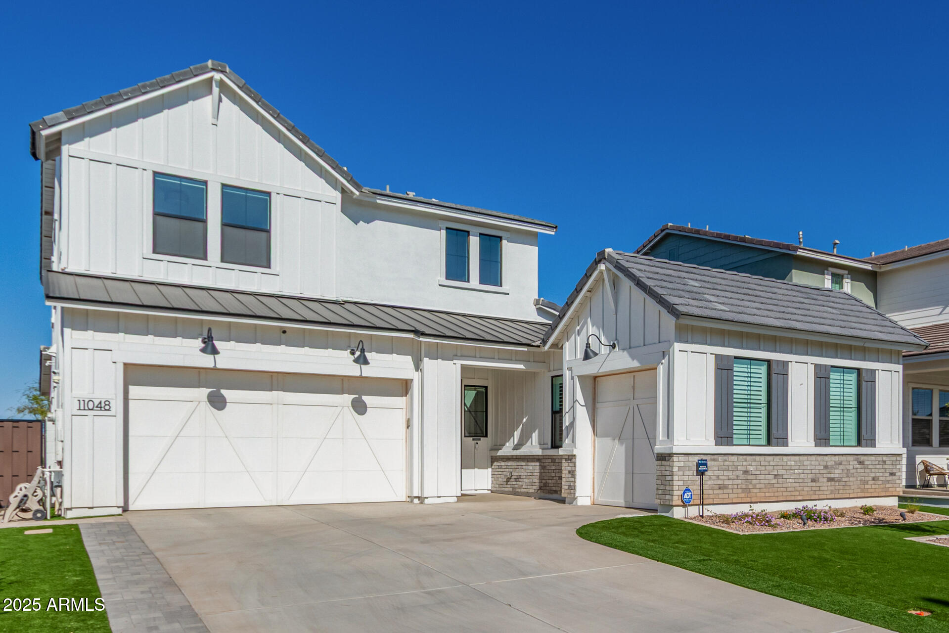11048 East Utah Avenue Mesa, AZ 85212 - Photo 1 of 29 a front view of a house with a yard and garage