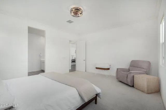 a bedroom with bed and a couch