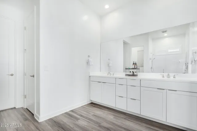 a bathroom with a double vanity sink and mirror