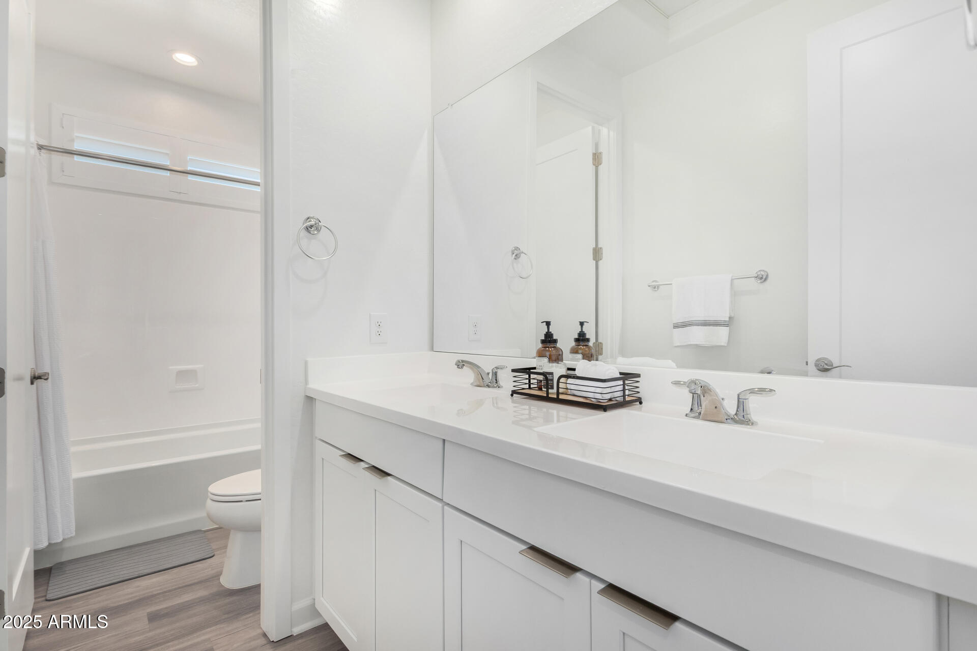 11048 East Utah Avenue Mesa, AZ 85212 - Photo 20 of 29 a bathroom with a double vanity sink toilet and shower