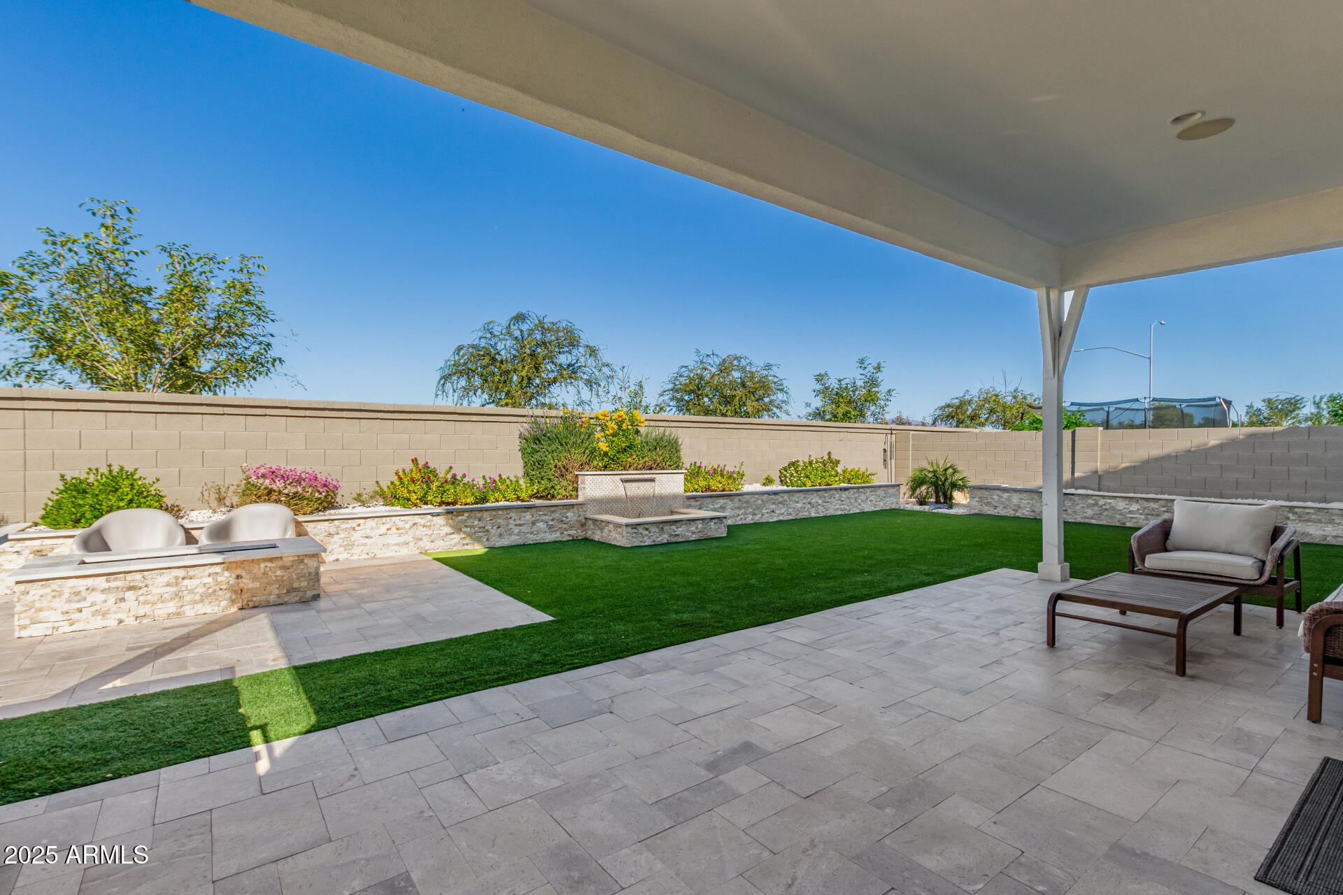 11048 East Utah Avenue Mesa, AZ 85212 - Photo 24 of 29 a view of a patio with a table and chairs under an umbrella