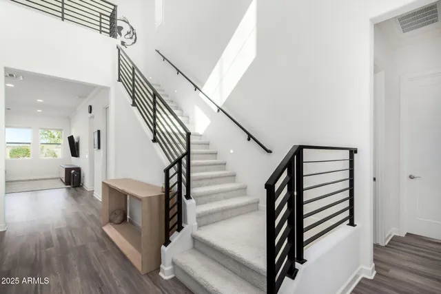 a view of entryway and hall with wooden floor