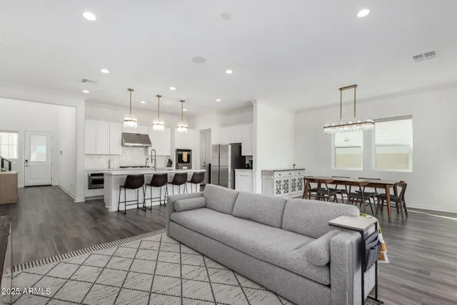 a living room with furniture and kitchen view