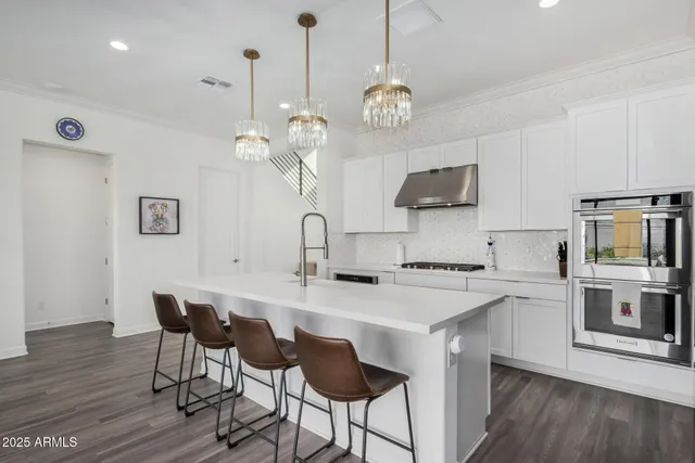 a kitchen with a kitchen island and stainless steel appliances