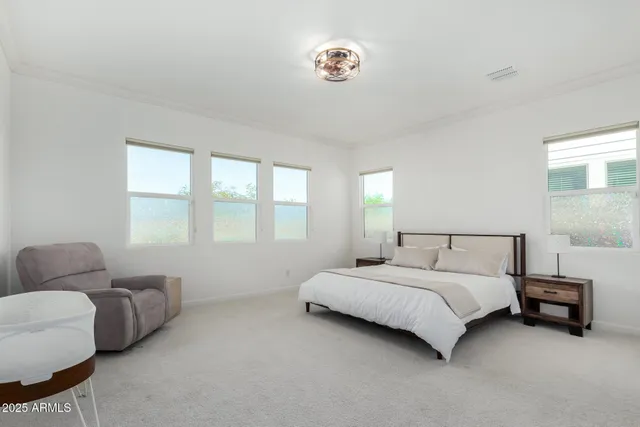 a bedroom with a bed couch and a window