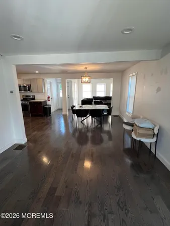 a living room with furniture and a dining table with kitchen view