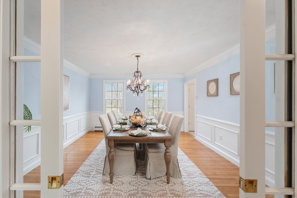60 Golden Run Road Bolton, MA 01740 - Photo 15 of 42 a dining room with furniture a chandelier and wooden floor