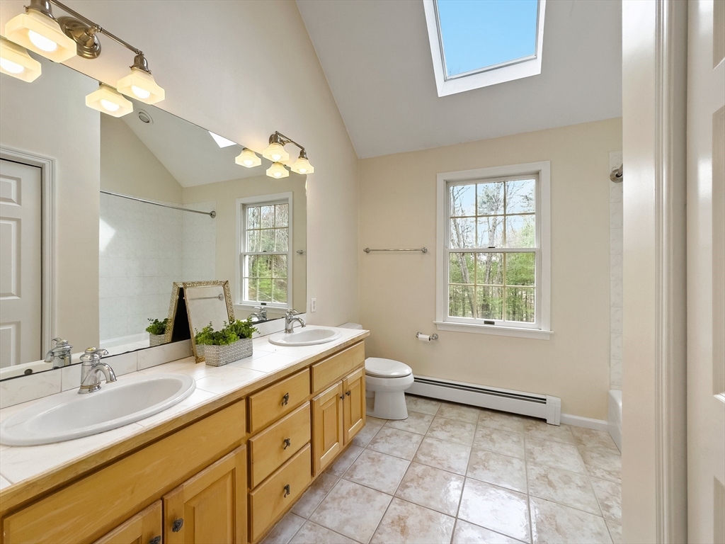 60 Golden Run Road Bolton, MA 01740 - Photo 26 of 42 a spacious bathroom with a double vanity sink a mirror and a bathtub