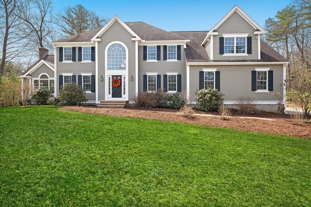 60 Golden Run Road Bolton, MA 01740 - Photo 34 of 42 a front view of a house with a garden and trees