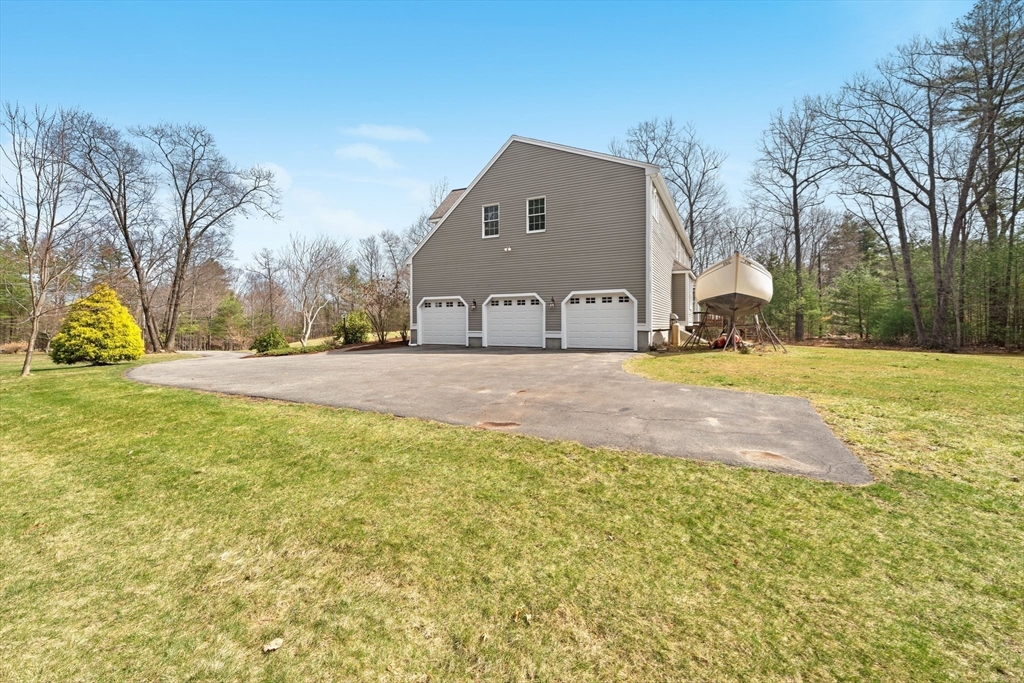 60 Golden Run Road Bolton, MA 01740 - Photo 35 of 42 a front view of house with yard and trees