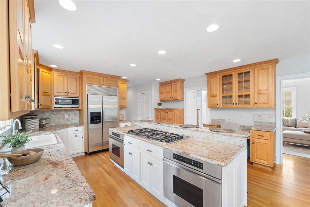 60 Golden Run Road Bolton, MA 01740 - Photo 6 of 42 a kitchen with stainless steel appliances kitchen island granite countertop a stove refrigerator and cabinets