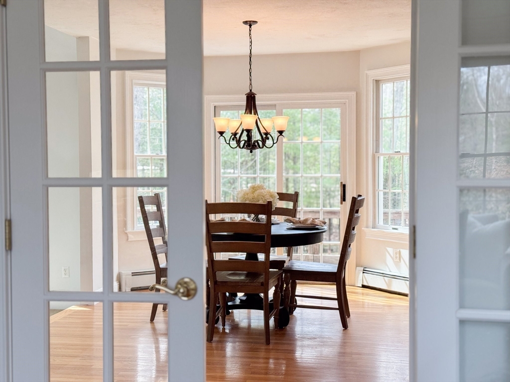 60 Golden Run Road Bolton, MA 01740 - Photo 10 of 42 a view of a dining room with furniture window and wooden floor