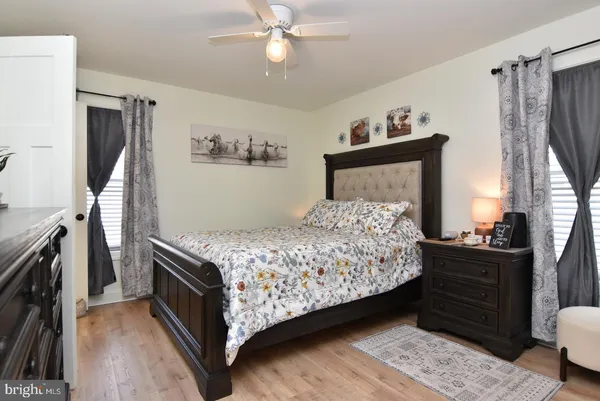 a bedroom with a bed dresser and a window
