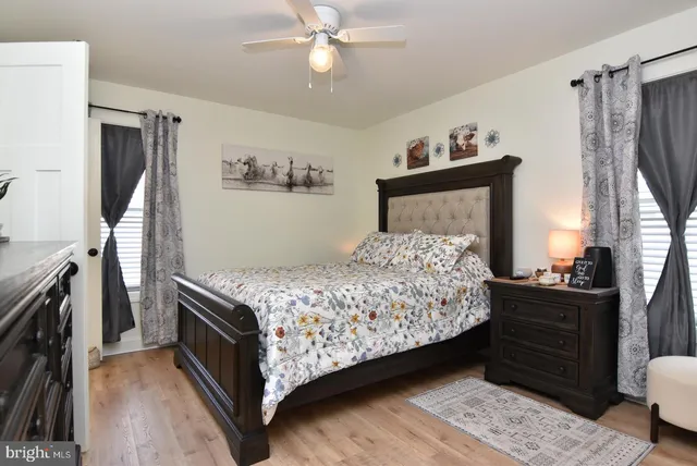 a bedroom with a bed dresser and a window