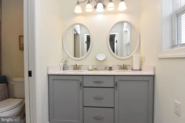 a bathroom with 2 sink and a mirror