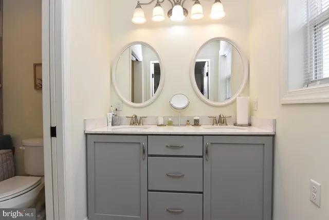 a bathroom with 2 sink and a mirror