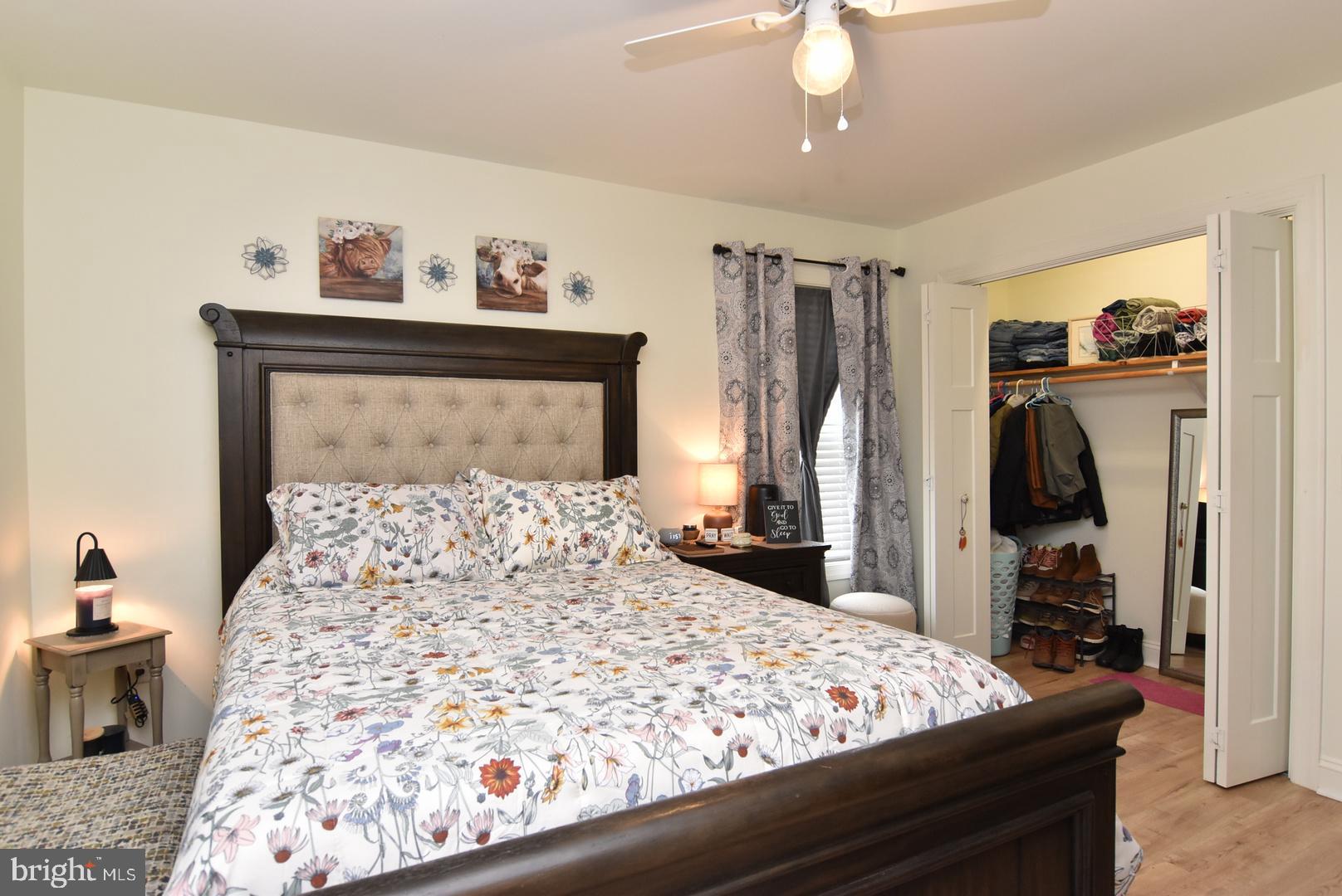 411 Conwell Street Milton, DE 19968 - Photo 18 of 21 a bedroom with a bed and a mirror on the dresser