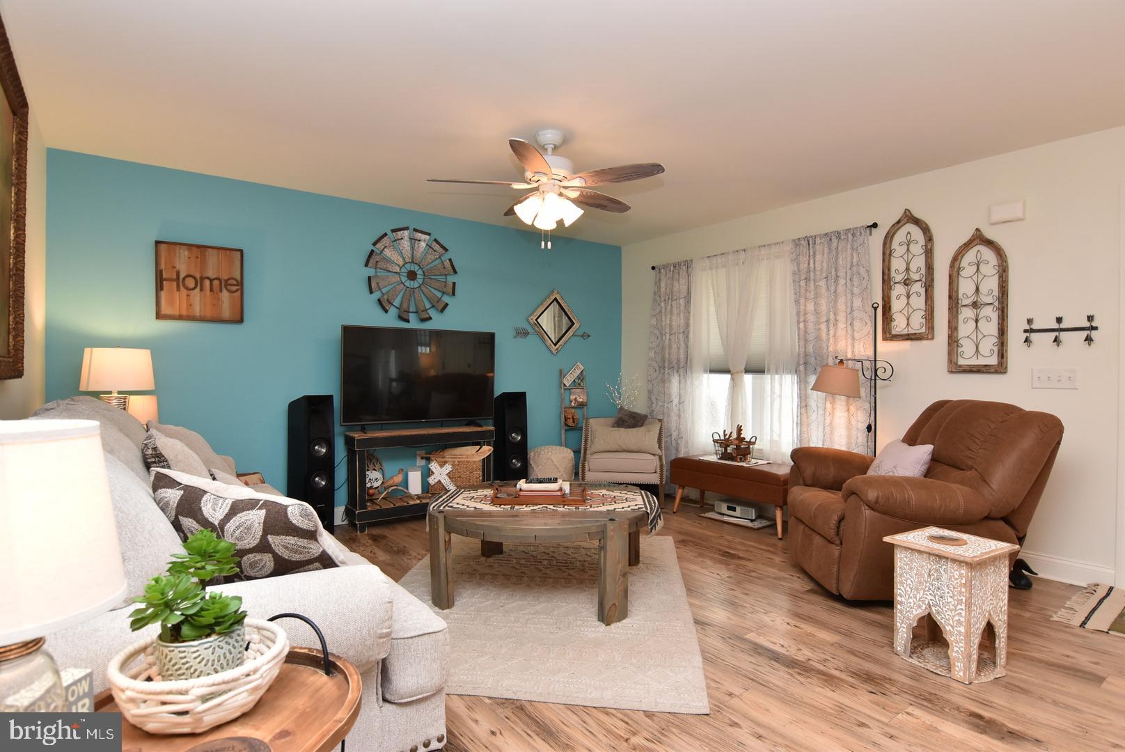 411 Conwell Street Milton, DE 19968 - Photo 5 of 21 a living room with furniture a flat screen tv and a window