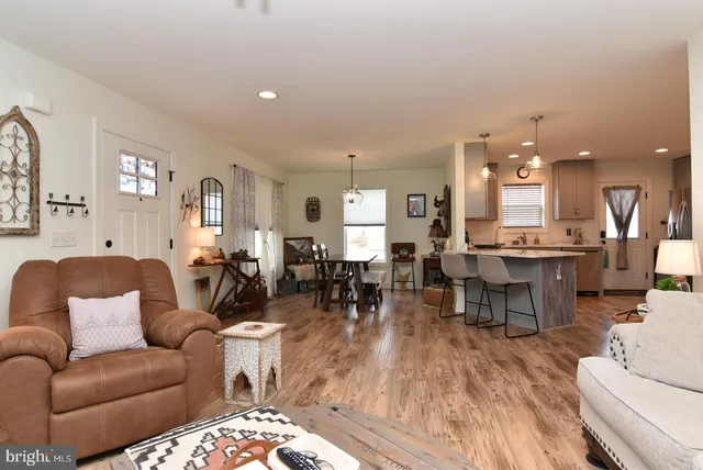 a living room with furniture kitchen view and a dining table