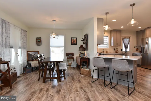 a dining room with furniture window and wooden floor