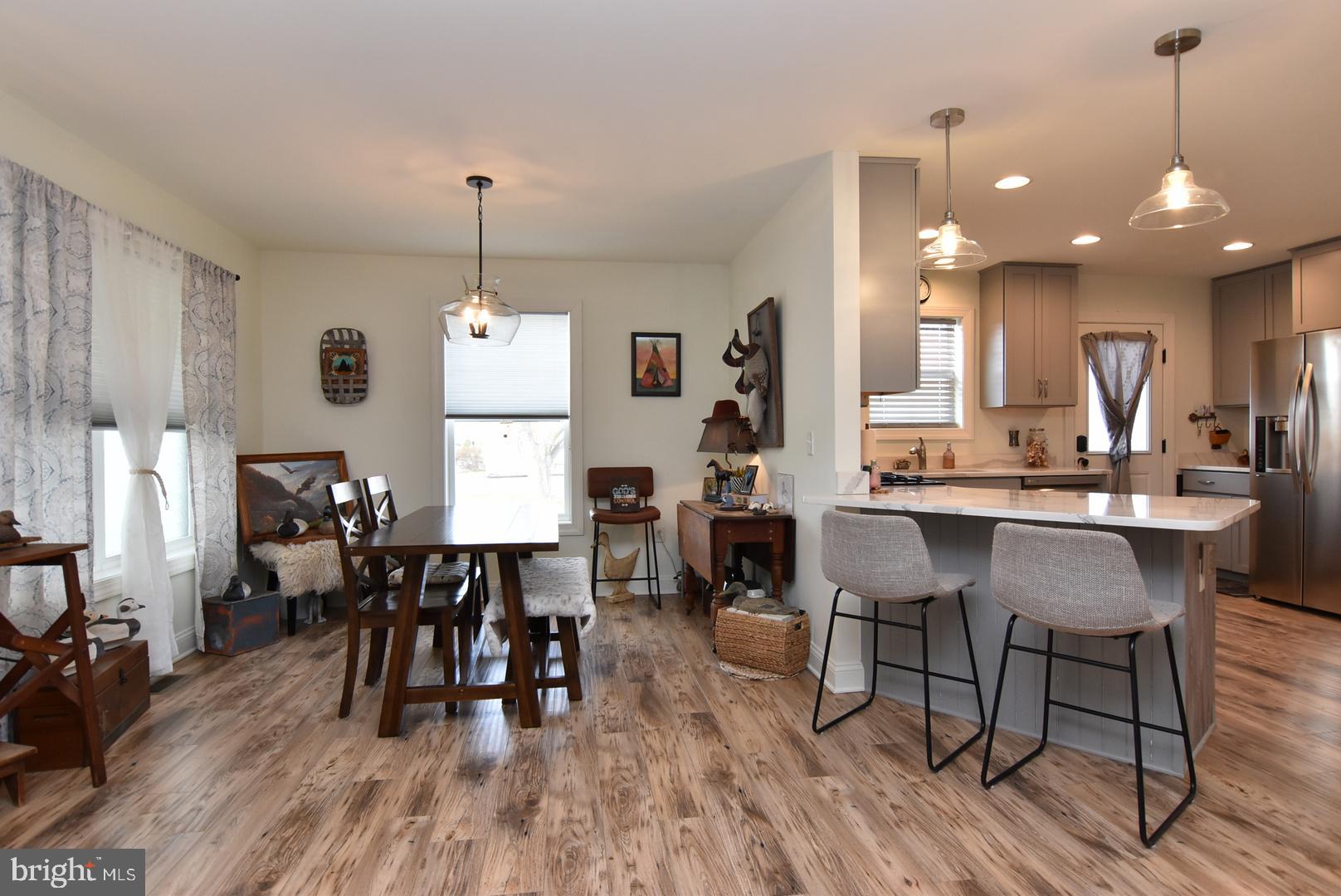 411 Conwell Street Milton, DE 19968 - Photo 7 of 21 a dining room with furniture window and wooden floor