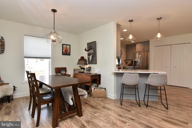 a view of a dining room with furniture and wooden floor
