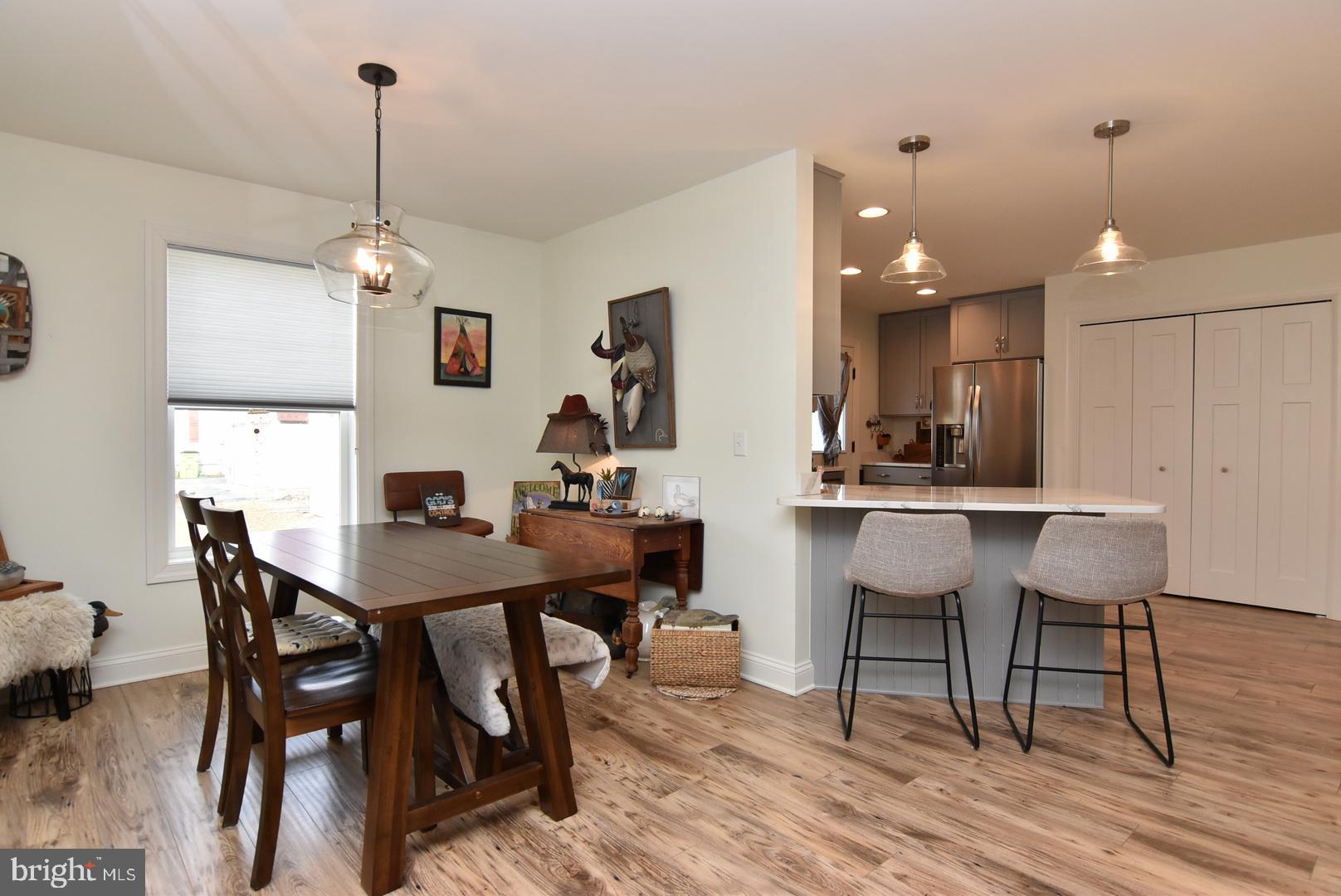 411 Conwell Street Milton, DE 19968 - Photo 8 of 21 a view of a dining room with furniture and wooden floor